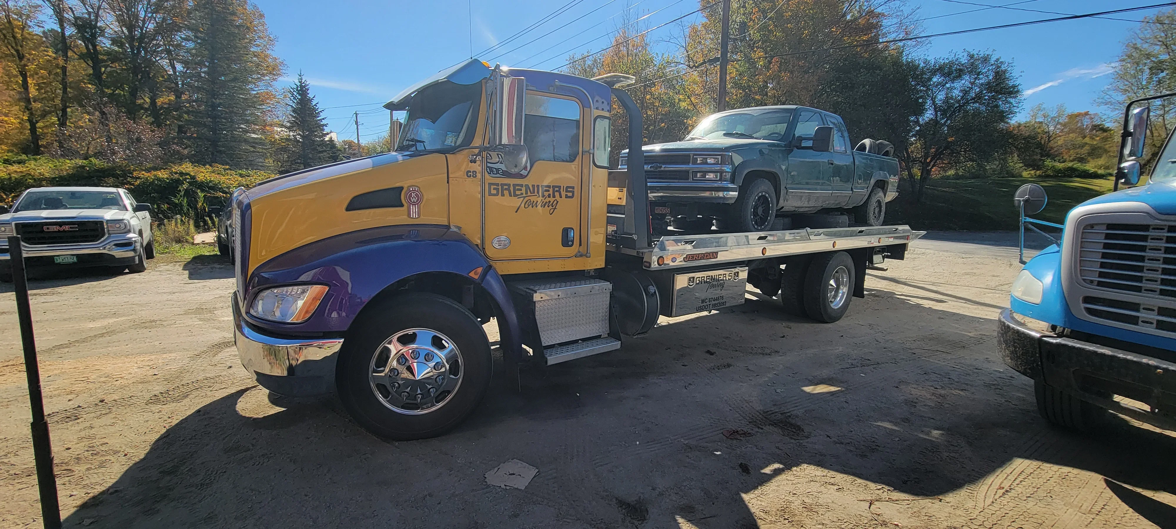 Flatbed Tow Truck Hauling Pickup