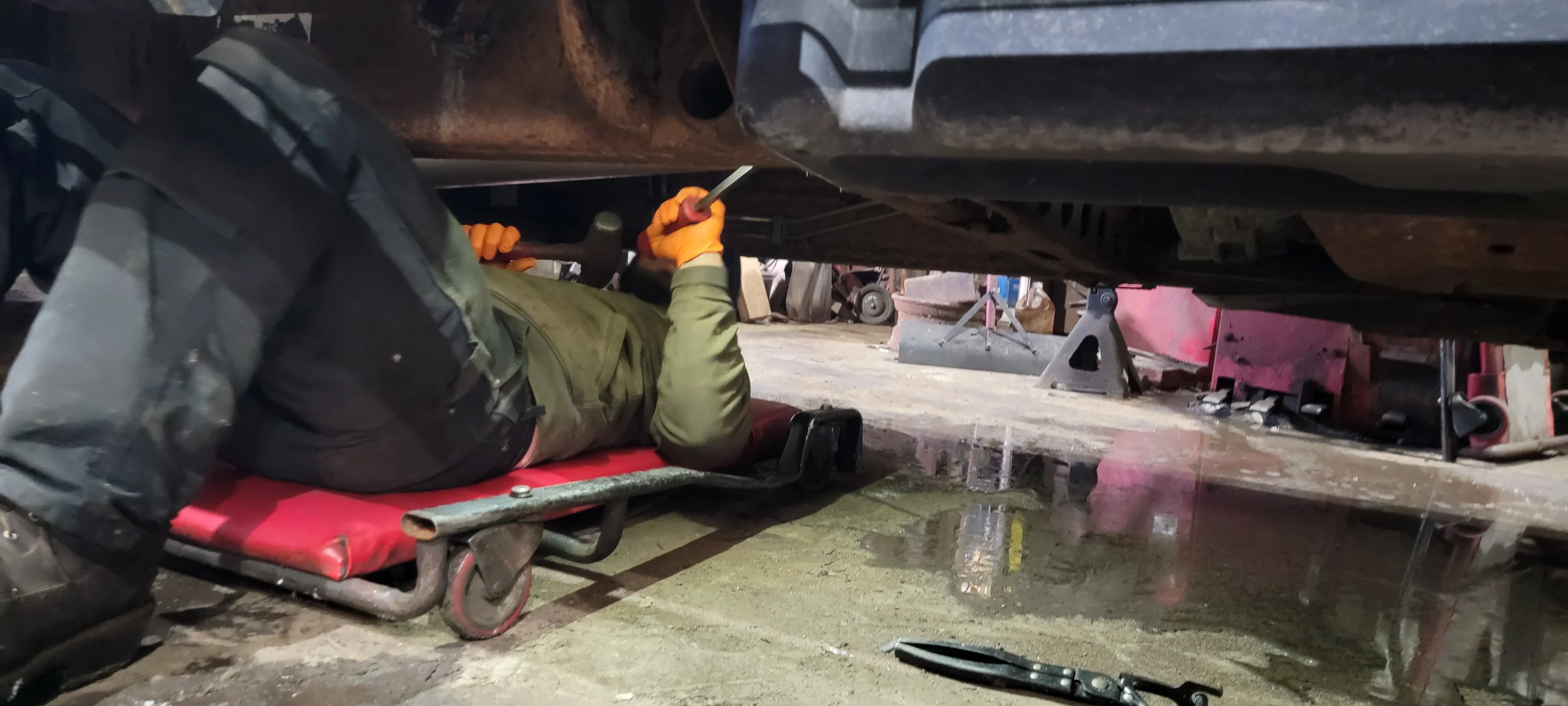 Mechanic Repairing Truck Undercarriage