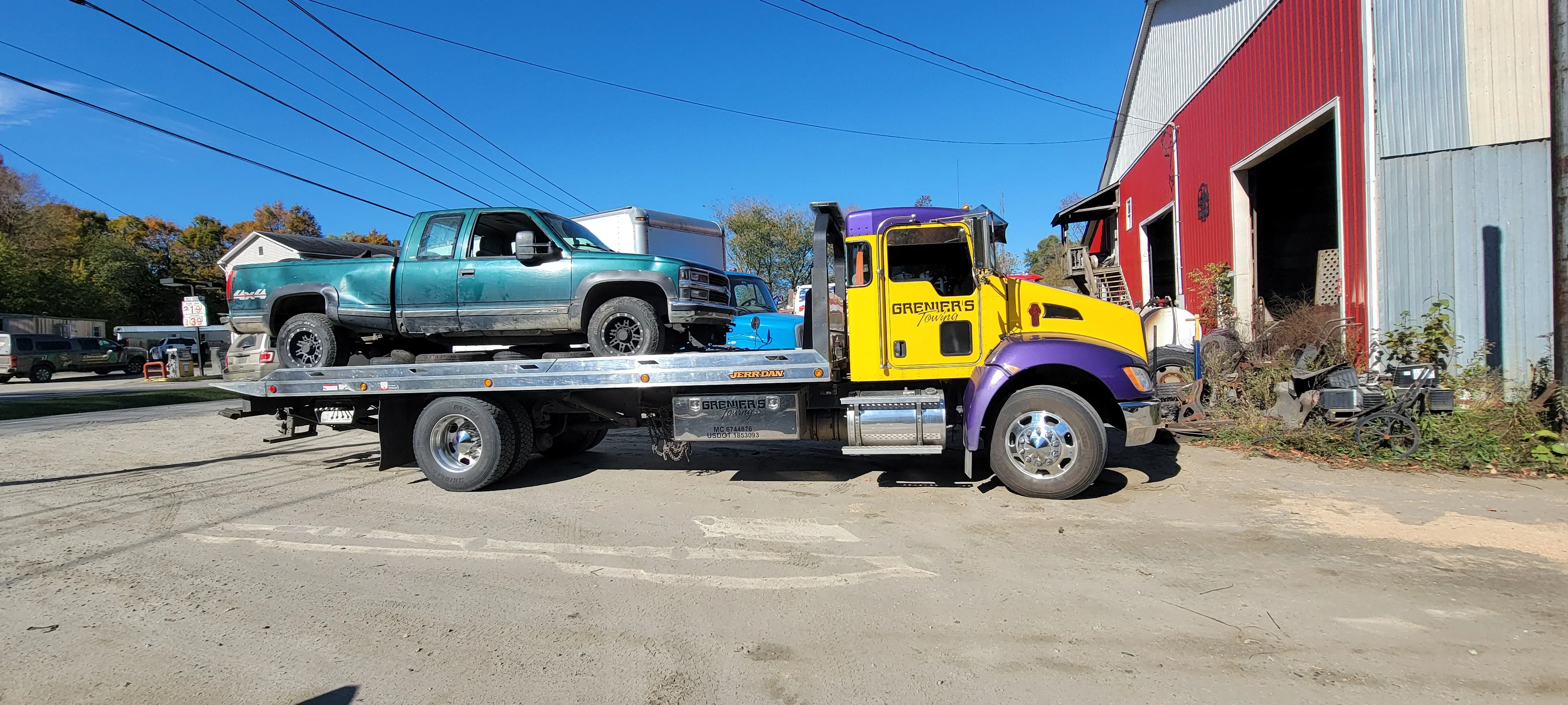 Flatbed Tow Truck Transporting Pickup