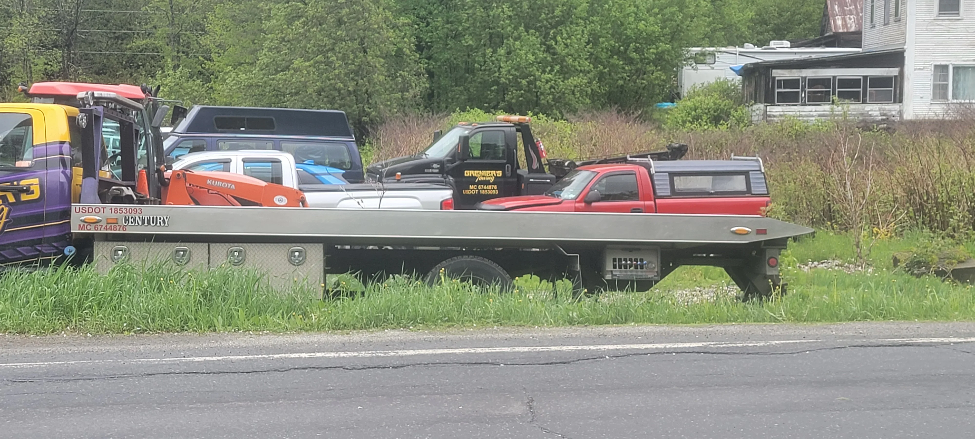 Flatbed Tow Truck Hauling Vehicles